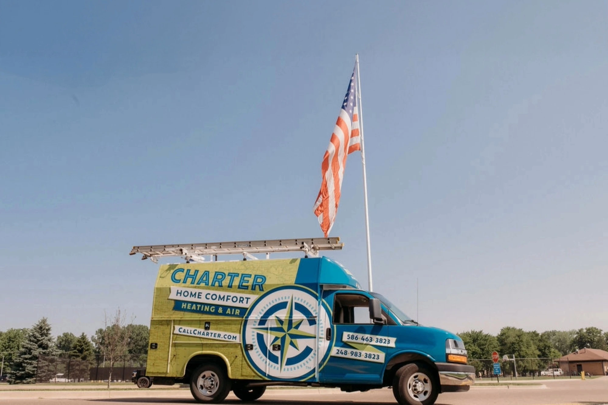 Charter home comfort van park in front of the American Flag at Brandenburg Park Chesterfield Mi 